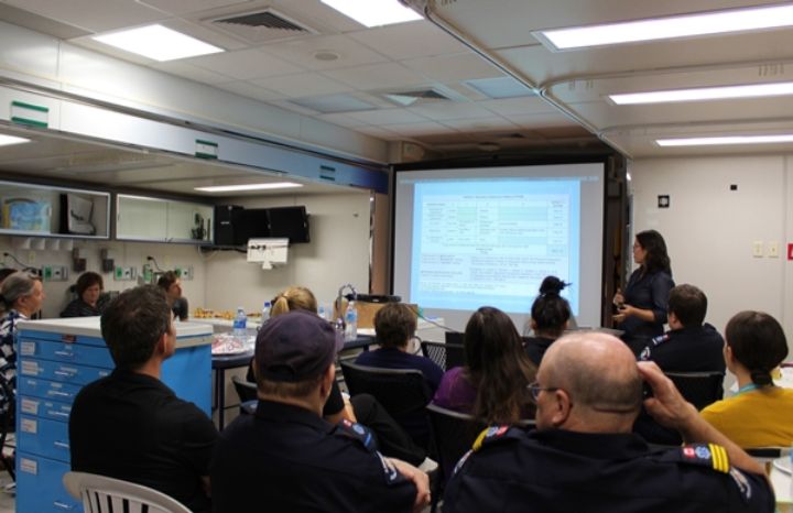 Physician presenting to clinical staff inside the Mobile Medical Unit