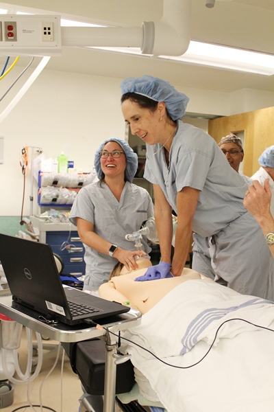 Clinician practicing chest compressions on simulation doll